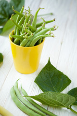 green asparagus beans in a yellow cup