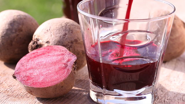 Pouring beetroot juice, close-up.
