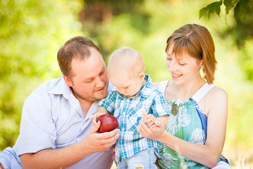 Mom, dad and son have a picnic