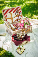 Two glasses of white wine with picnic basket. 