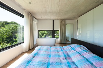 Modern villa, interior, bedroom with bathtub
