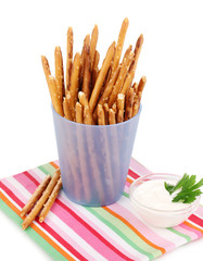 Tasty crispy sticks in purple plastic cup isolated on white
