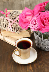 Beautiful pink roses in vase on wooden table close-up