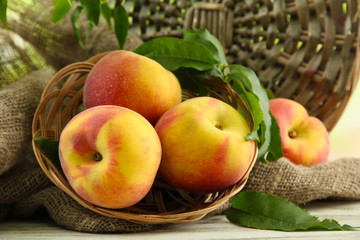Ripe sweet peaches on wooden table, close up