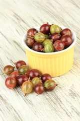 Fresh gooseberries in bowl on table close-up