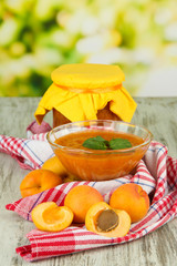 Apricot jam in glass bowl and fresh apricots,
