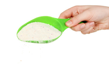 Measuring cup with washing powder  in hand isolated on white