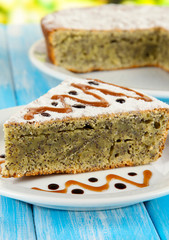 Delicious poppy seed cake on table close-up