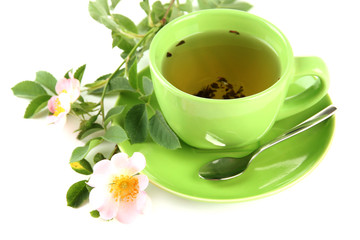 Cup of herbal tea with hip rose flowers, isolated on white