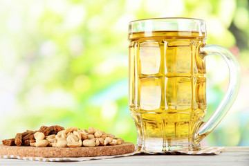 Beer in glass crunches, and nuts