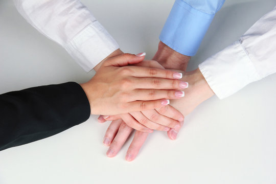 Group of young people's hands isolated on white