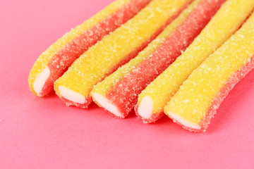 Sweet jelly candies on pink background