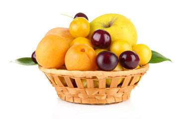 Bright summer fruits in basket isolated on white