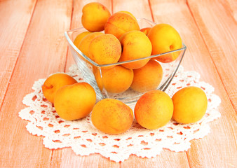Fresh natural apricot in bowl on wooden table