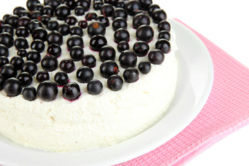Cheesecake with fresh berries on white plate closeup