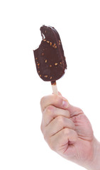 Bitten chocolate-coated ice cream on stick.