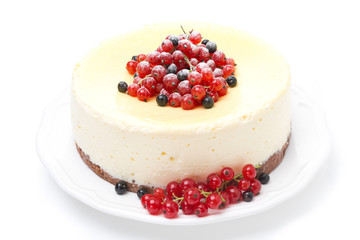 cheesecake decorated with red and black currants, isolated