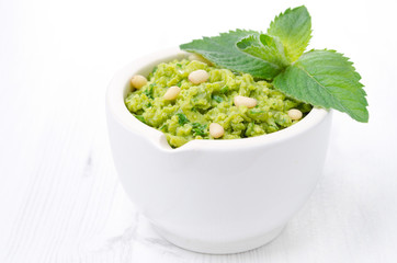 pesto with green peas and mint on a white background, horizontal