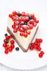 piece of cheesecake with red and black currants, selective focus