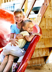Fototapeta na wymiar Children move out to slide in playground