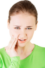 Fototapeta premium Teen woman having a terrible tooth ache.