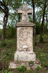Fototapeta premium Weathered tombstone in an old cemetery