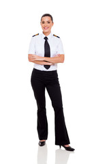 female young airline co-pilot with arms crossed