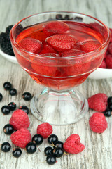 Jelly with fresh berries on wooden table close up