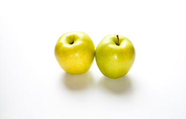 Two Golden Delicious Apples on White Counter