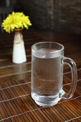 Glass of cold drink water on wooden table