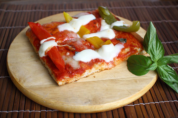 Vegetarian pizza with peppers, tomatoes,basil and cheese on wood