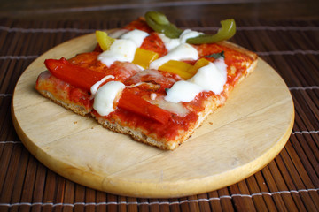 Vegetarian pizza with peppers, tomatoes and cheese on wood table