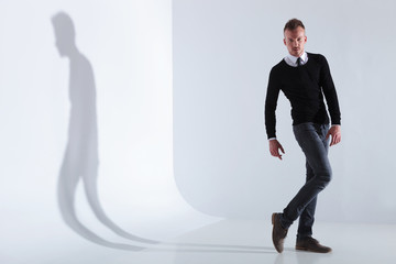 Fototapeta premium casual man poses with a bent leg