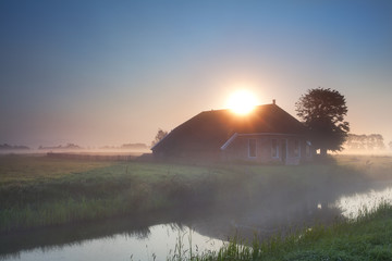 sunbeams over farmhouse