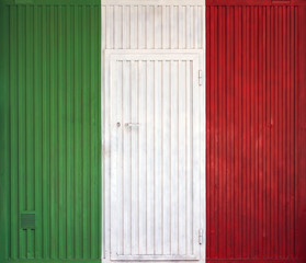 Italian flag on the background of old locked doors