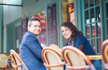 Cheerful couple in an outdoor cafe