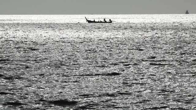 Lonely fishing boat in the sea. Long shot.