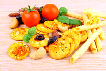 Mediterrean snack, pizza crackers, dried olives, nuts, tomatoes