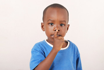 Un enfant avec le doigt sur la bouche