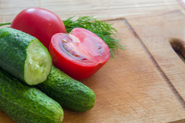 fresh cucumber and tomatoes on the board