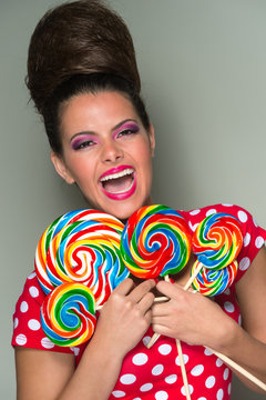 Playful vivacious woman with lollipops
