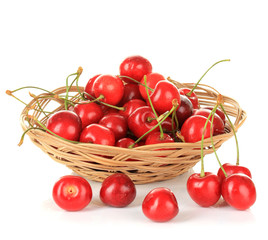 Cherry berries in wicker basket isolated on white