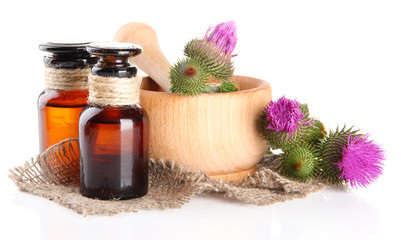 Obraz na płótnie Canvas Medicine bottles and mortar with thistle flowers, isolated