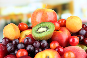 Assortment of juicy fruits on bright background