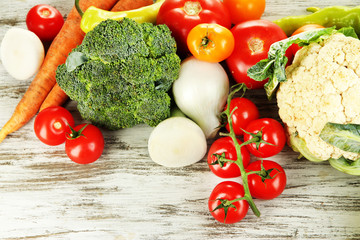 Fresh vegetables in basket on wooden table close-up