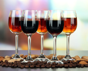 Glasses of liquors with almonds and coffee grains,