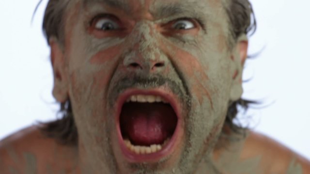 fierce facial expressions and grimaces of a primitive man