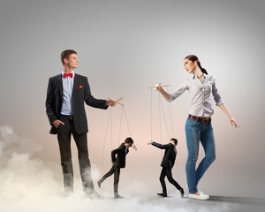 Businesspeople with marionettes