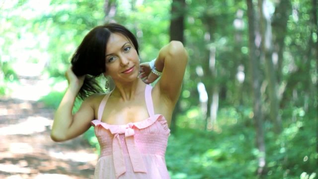 Close-up of young brunette girl smiling at camera.