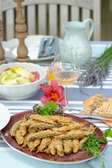 Fried sardines with potato salad, bread